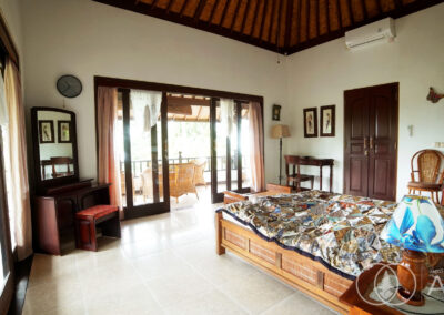 Solid bedroom furniture in Balinese style house with access to ensuite bathroom