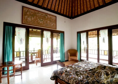 Balinese wooded bed-room furniture with sliding doors opening onto the outdoor balcony