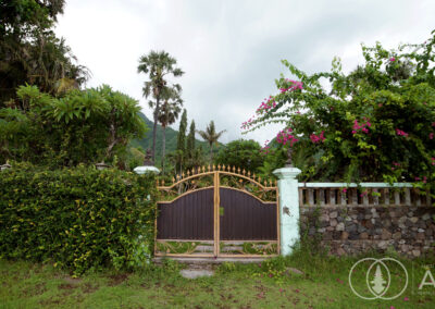 Entrance gate and wall looking back towards a beachfront villa in Amed, Bali.