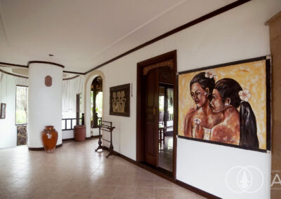 Traditional Balinese house with artwork on the wall.