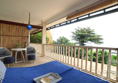 Balcony of beachfront house in Amed with sunloungers looking at the Bali Sea