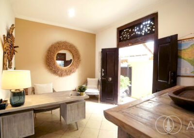 Entry space of a beachfront house in Amed with large wooden teak doors