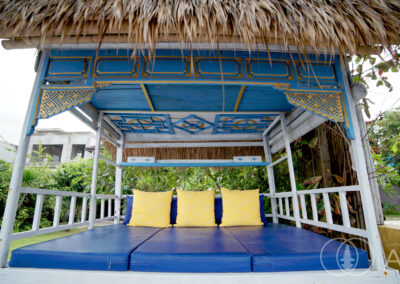 Blue coloured day-bed in the garden of a beach front house in Amed