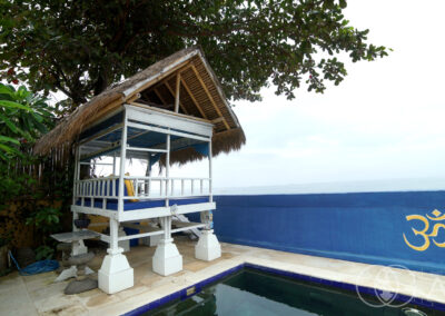 Shaded day bed over looking the Bali Sea from a beachfront house in Amed.