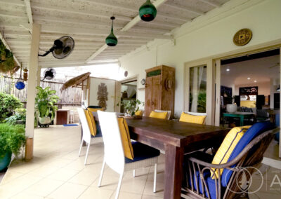 Teak wooden dining table on the outdoor terrance of a beachfront house in Amed