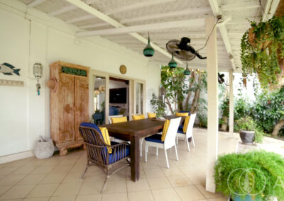 Outdoor dining area looking at the garden of a beach front house in Amed.