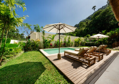 Sun beds around a swimming pool of a holiday home on the Vesica Villas Celuke development in Amed.